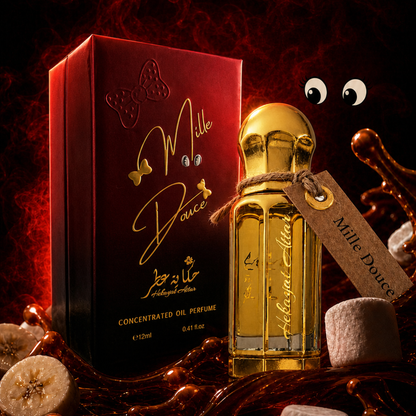 A bottle of Mille Douce concentrated oil perfume with a gold cap and a kraft paper tag, displayed next to its red box with gold lettering. The scene is styled with chocolate drizzle, banana slices, and a decorative eye prop against a dark red background.